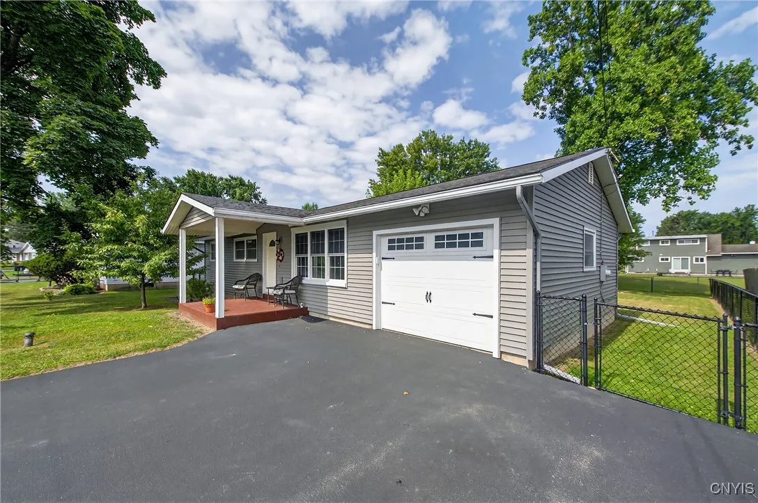 New front porch, trex deck, garage door, front windows and paved driveway
