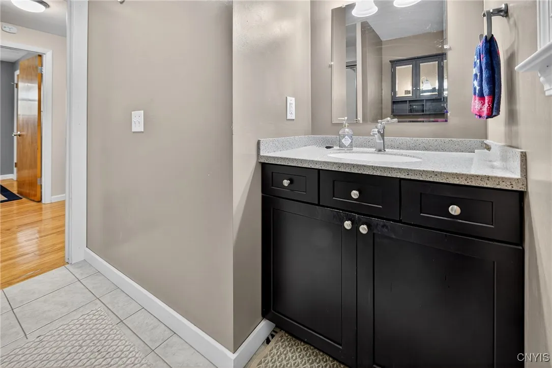 Main level bathroom is completely updated with new flooring, vanity and shower.
