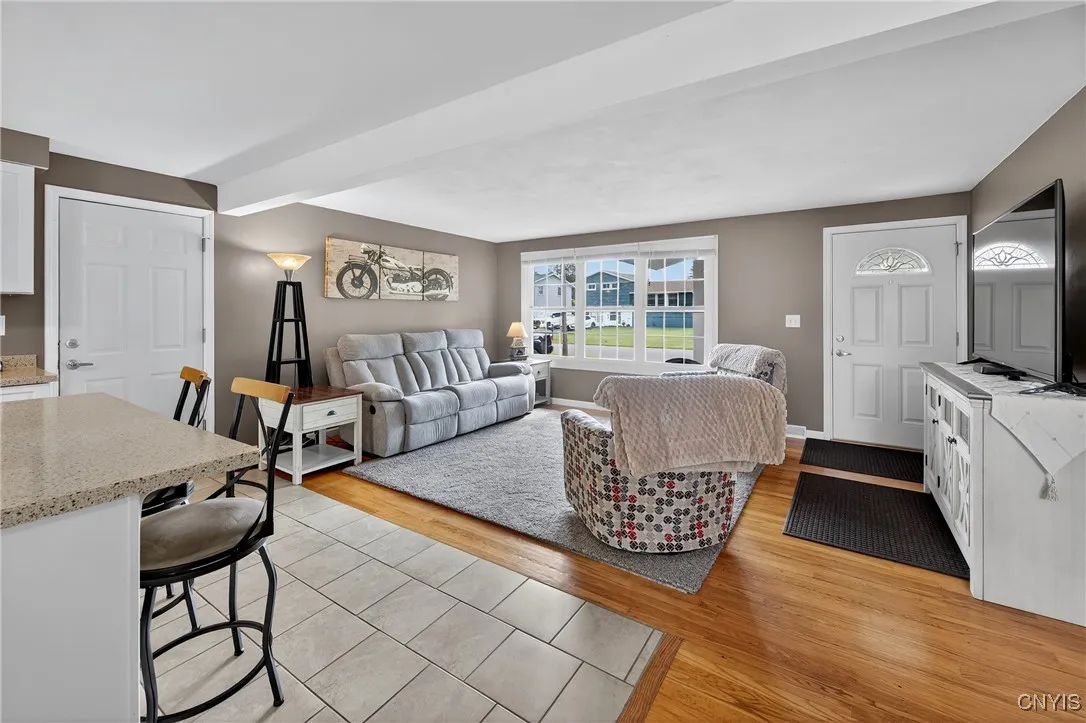 Spacious living room with door to garage and basement level