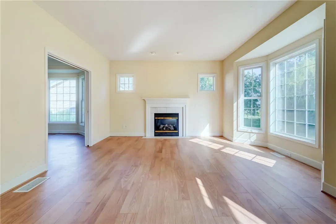 Large family room with gas fireplace open to living room and kitchen area