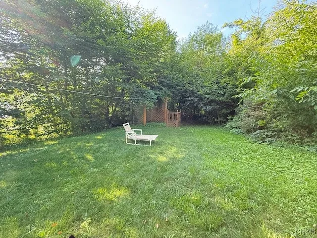 Side yard from solar panels view of outside shower gazebo