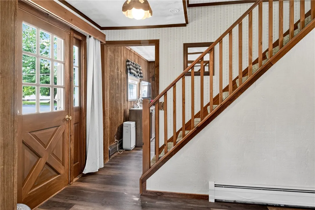 The front hallway leads to a family room to the left and the living room to the right