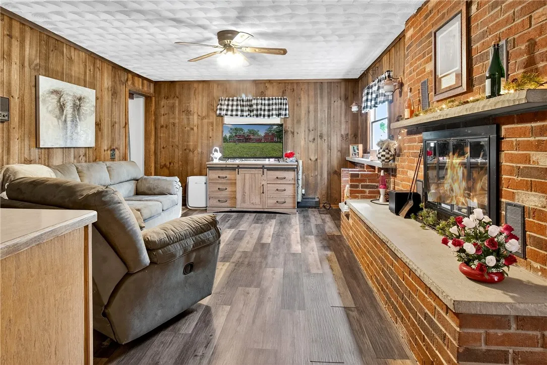 Family room off the kitchen with new laminate flooring and a wood burning fireplace