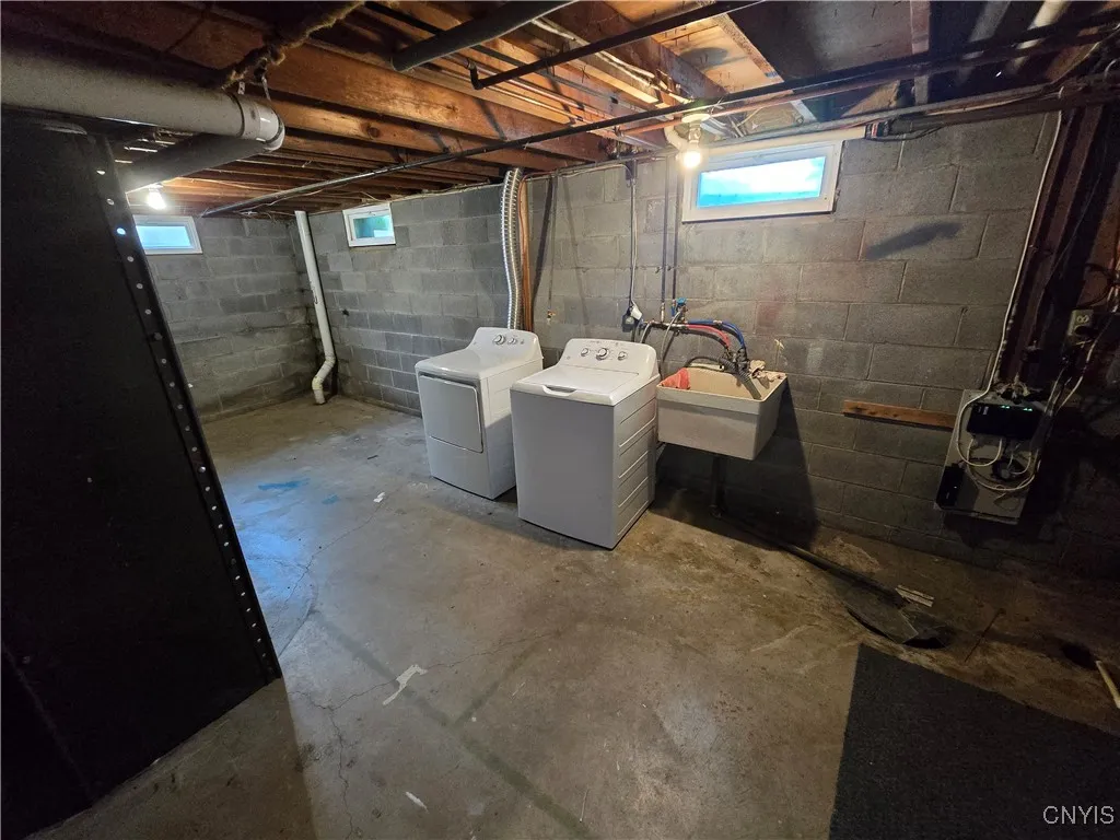 Basement laundry area with storage