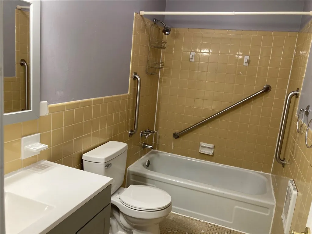 
Full bath with ceramic tub surround and new commode.