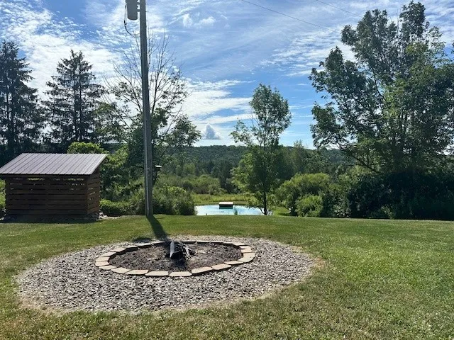 Large welcoming firepit overlooking your personal pond
