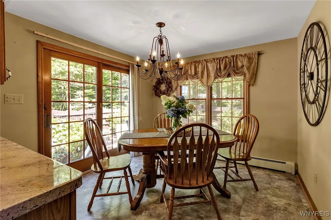Pretty chandelier in the eating area of the kitchen. Sliding door on the left