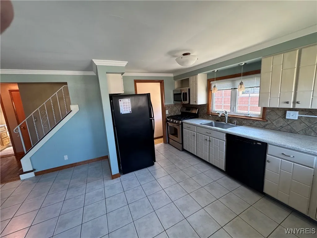 Fully applianced kitchen with plentiful cupboards and counter space