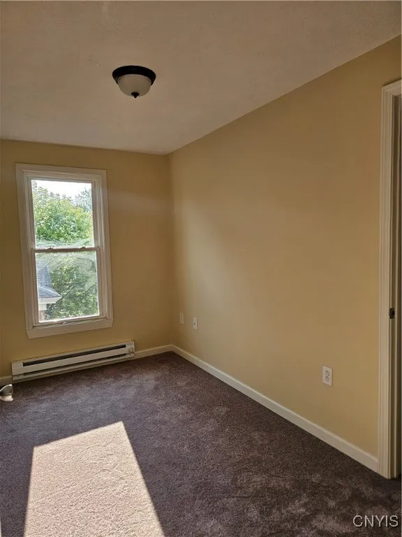 smaller bedroom with a closet and own thermostat