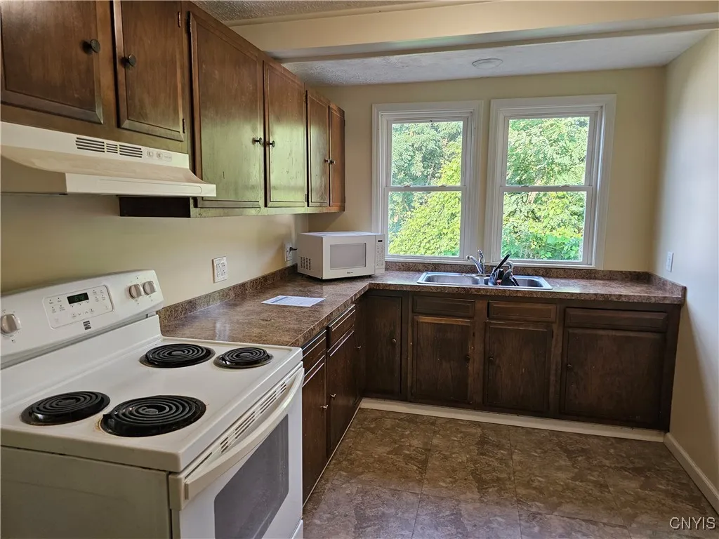 Kitchen Area that offers plenty of storage and has an eating area to the right.