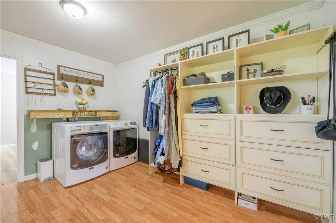 Primary Suite walk in closet and laundry center.