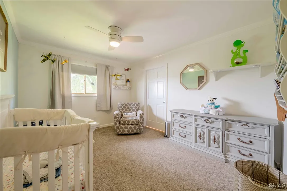 Bedroom #3 currently situated as a nursery.