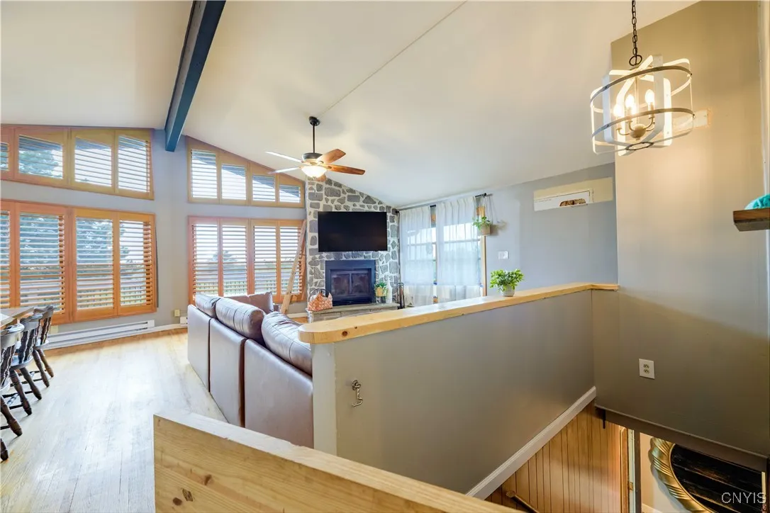 The stairway to the main level is gated for safety and convenience. Enter into your living room with vaulted ceilings and open dining room and then the kitchen. A beautiful wall of windows fills the space with natural lighting.