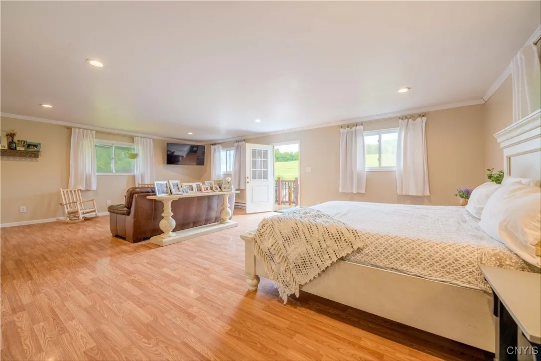 The Primary Suite located at the back of the home has access to the backyard and patio.
