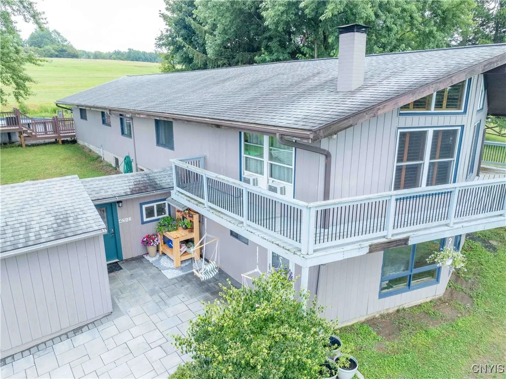 A bird's eye view of home's entrance with a  beautiful walkway and flower arranging station.