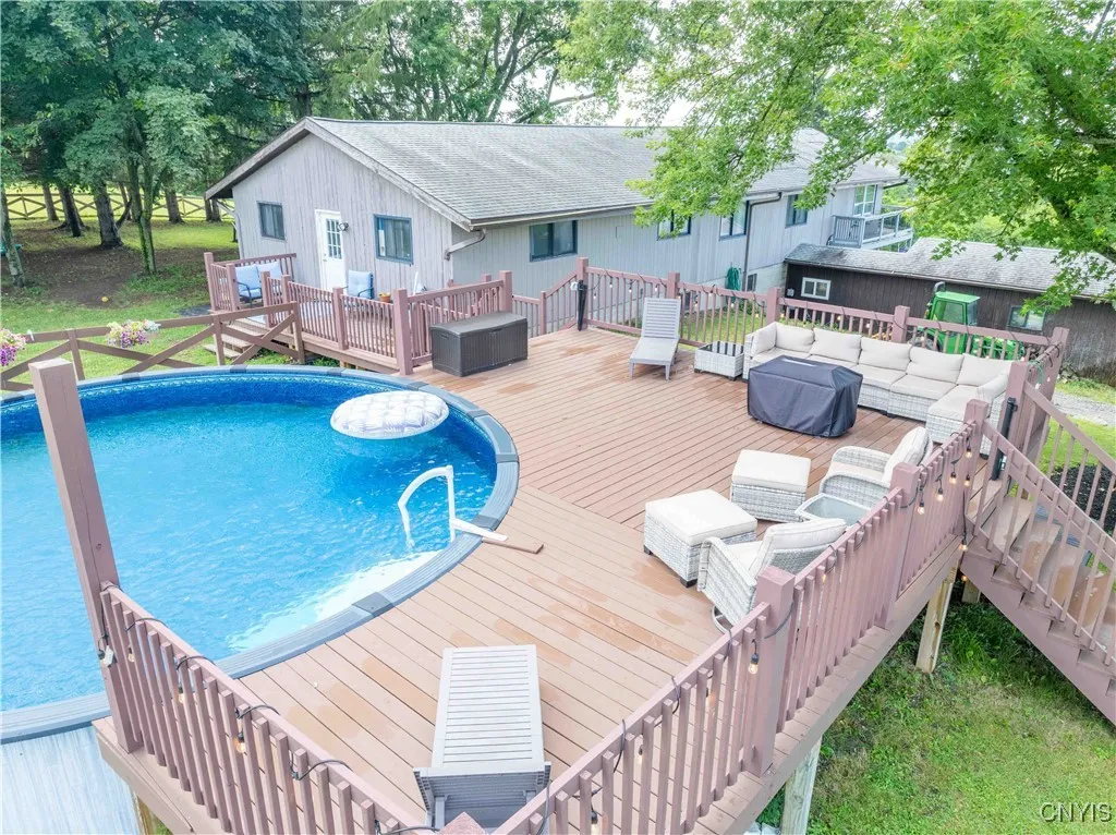 A backyard pool with connecting patios and decks. Pool has a new liner.
