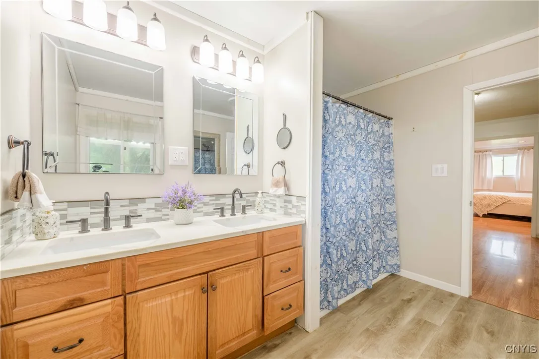 Primary Bathroom with a double sink vanity and tub/shower combo.