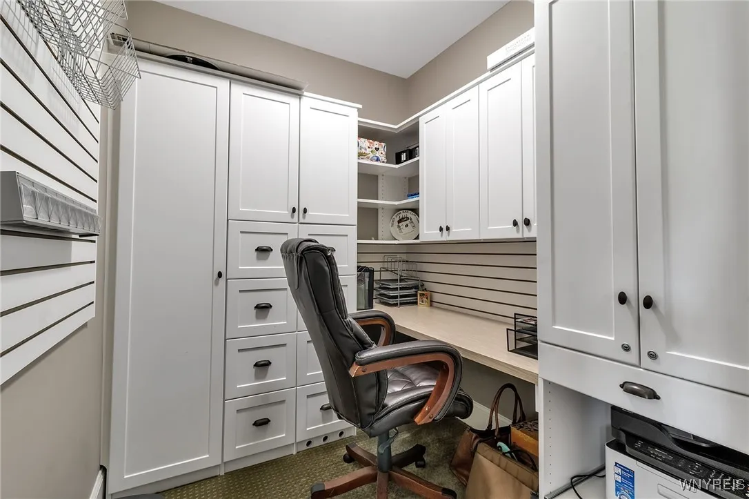 A second office space with dynamite shelving and pocket door for privacy.