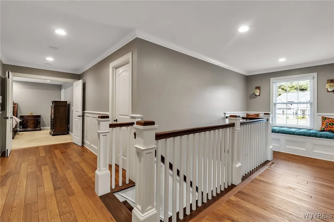 Upstairs hallway with cozy window seat.  Look at the detailed custom trims even upstairs!