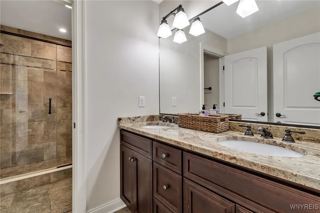 Hallway Bath with double sink and granite countertops.