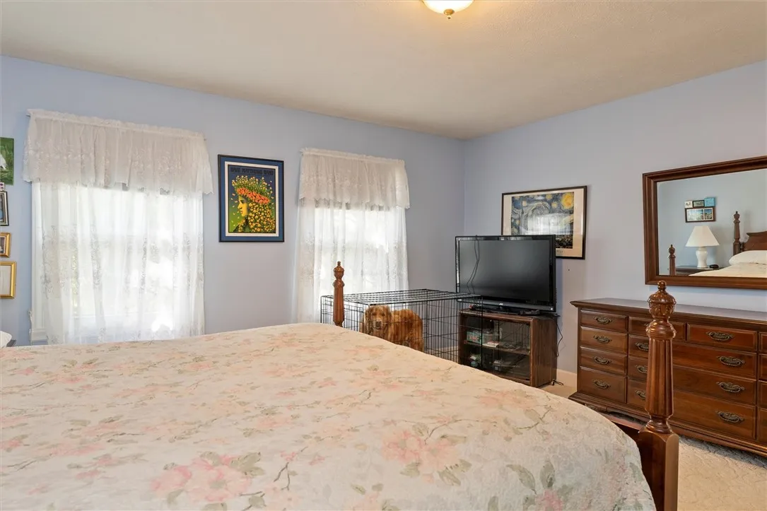 Primary bedroom with a walk in closet, ensuite bathroom with a jacuzzi tub, stand up shower.