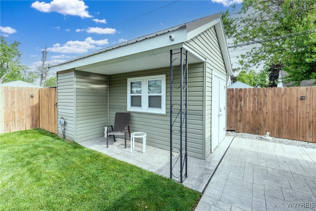 What a nice shed plus another spot to sit and enjoy the beautiful yard!
