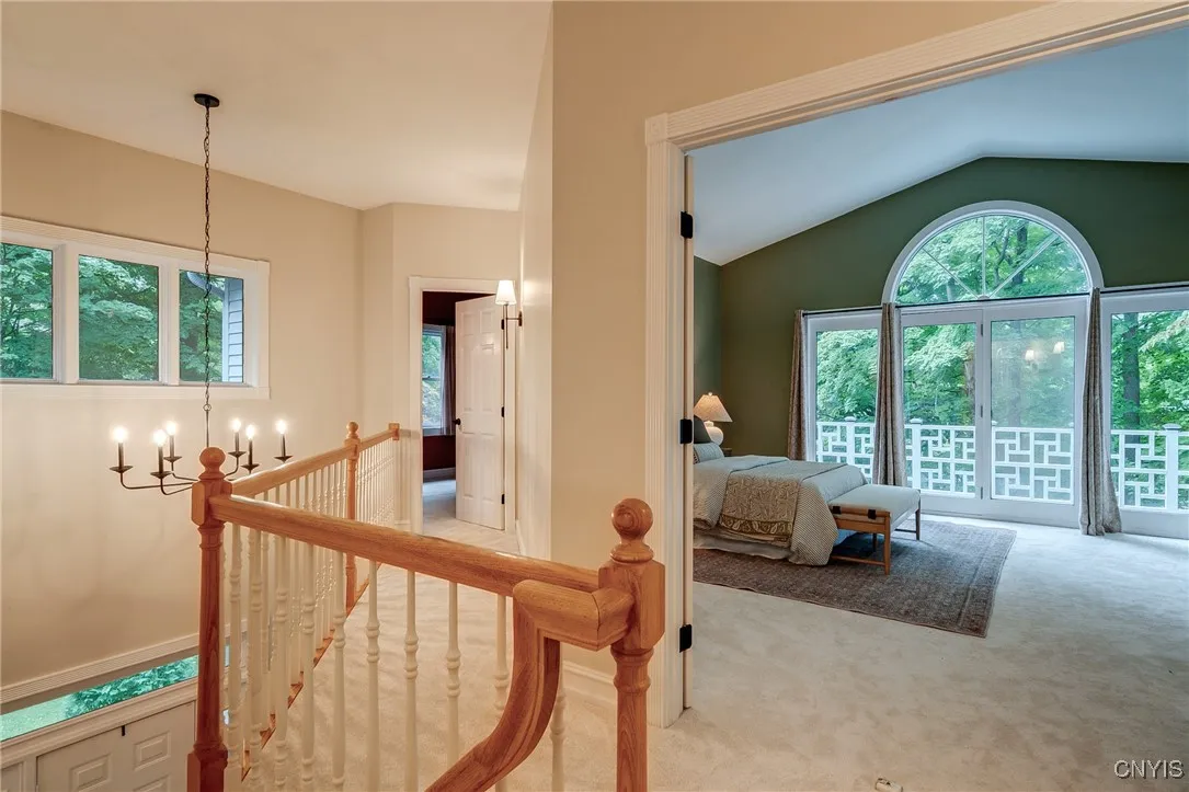 The Primary Suite is located at the top of the stairs and has a grand entrance with double doors and views to the Balcony