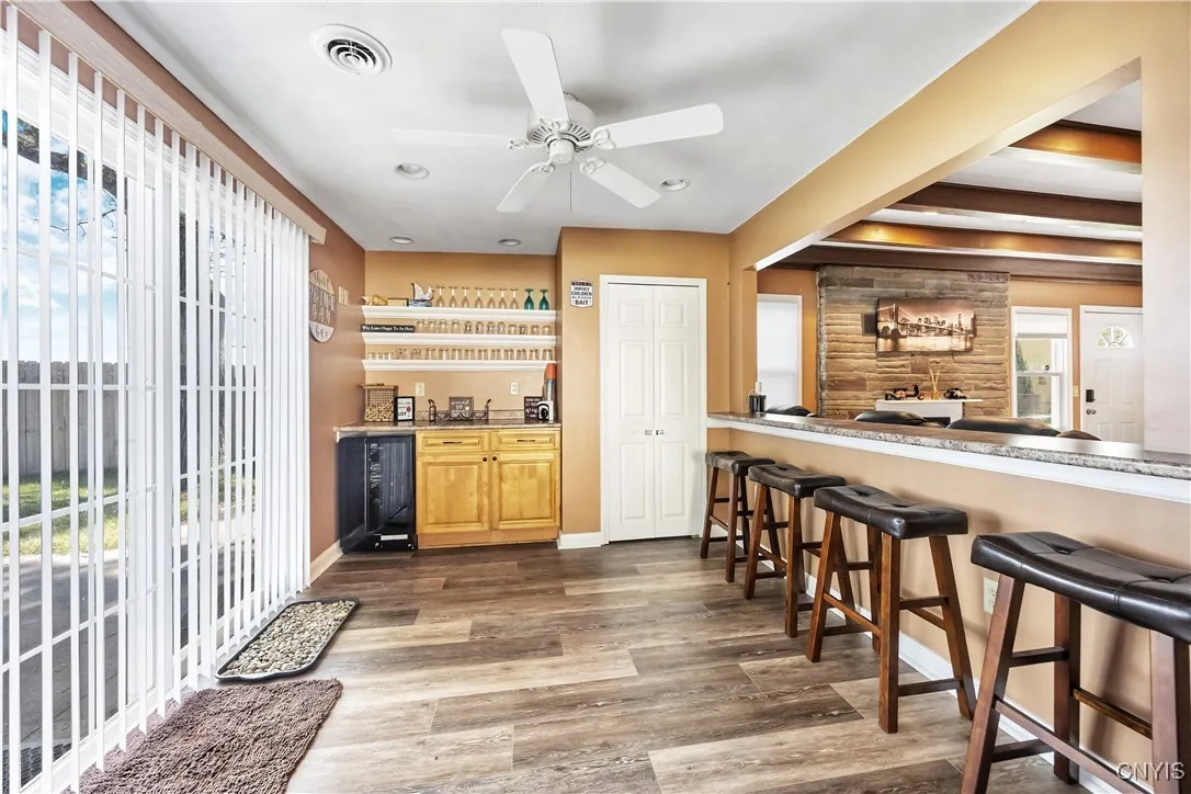 Here you can see the snack bar/pass thru to the Greatroom, the second Pantry, dry bar & wind chiller and the slider out to the Patio and waterfront - ideal extra space for indoor/outdoor entertaining!