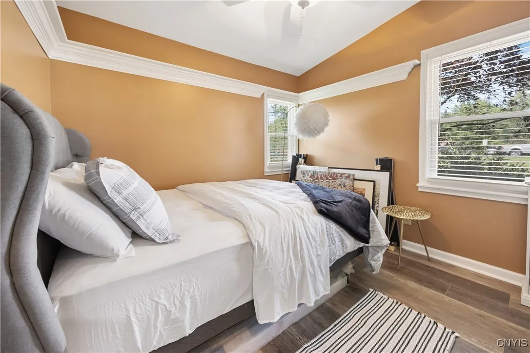 The Second Bedroom is also spacious with its vaulted ceiling, light fan, LVP flooring, and sharp accent trim work.