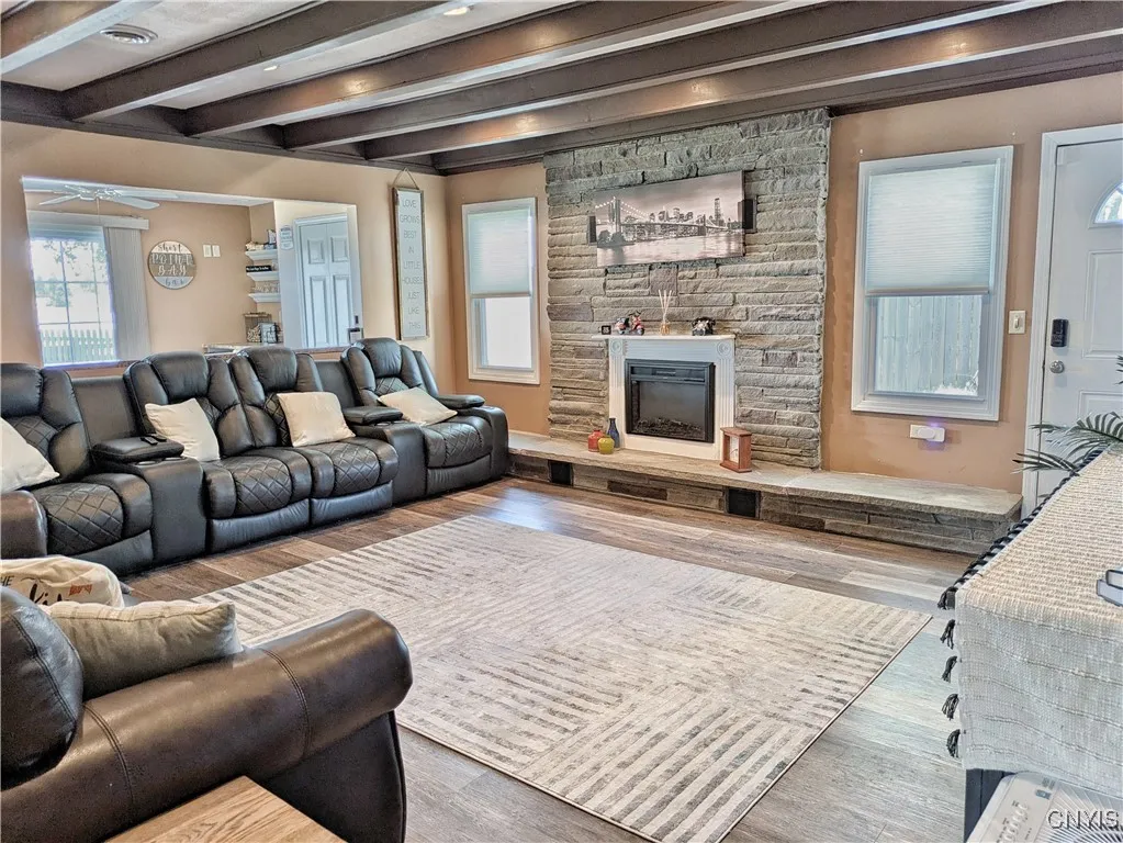 The Greatroom from the other side with a better view of the electric raised-hearth fireplace that will help keep this room cozy when the weather cools.