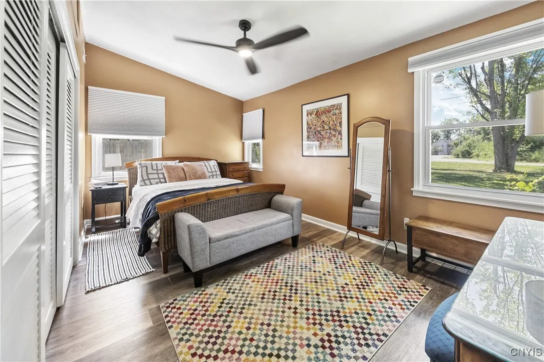 The Primary Bedroom features a dramatic vaulted ceiling with a lighted ceiling fan, LVP flooring, and a triple-wide closet.