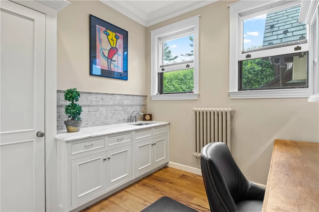 Adjacent to the kitchen, a modernized office provides a convenient space to get work done.