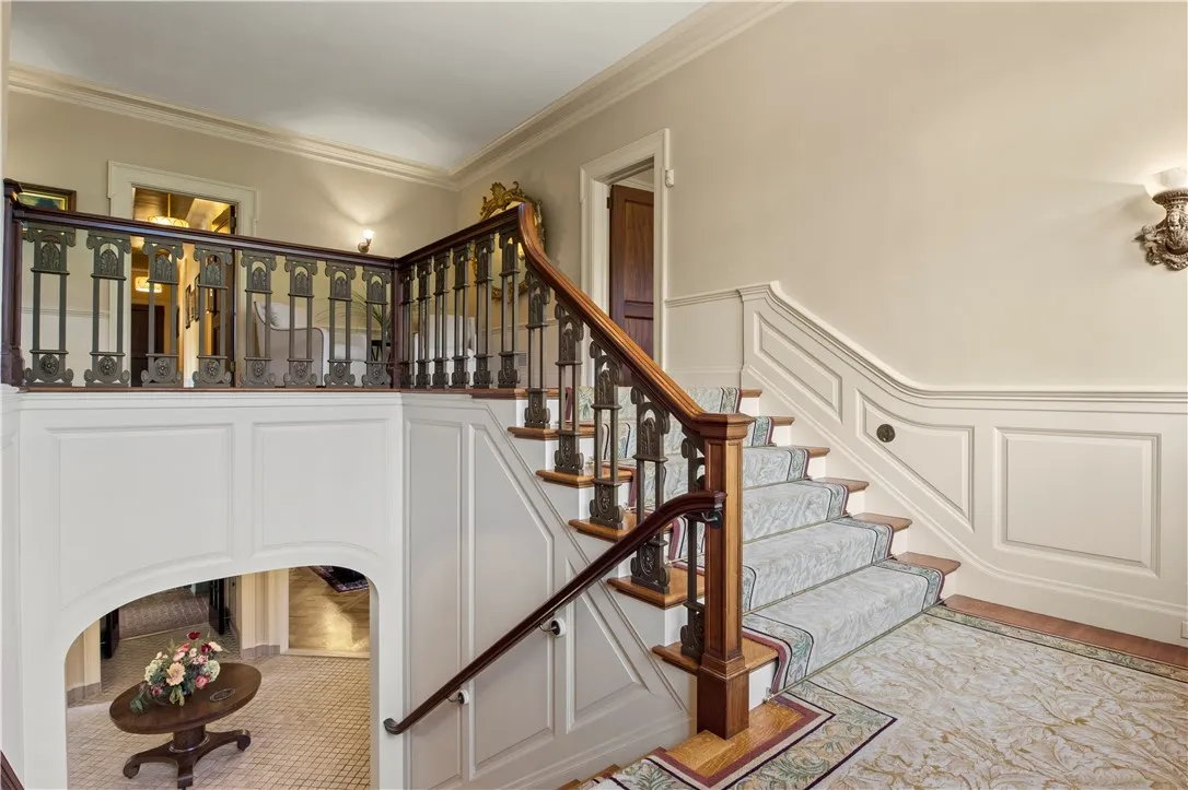 Ascend the grand and graceful staircase to the second floor.
