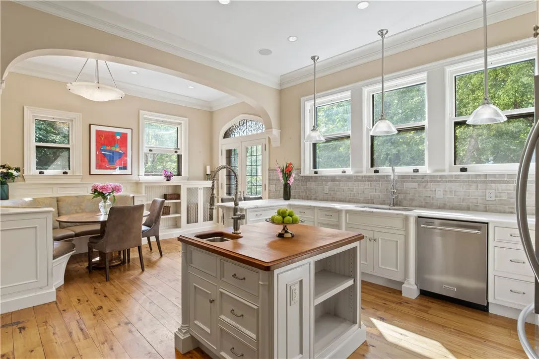 The updated kitchen is a culinary masterpiece, featuring an island with a teak top and bar sink and  marble countertops.

