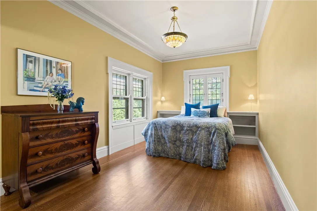 A charming bedroom features built-ins and ample natural light.
