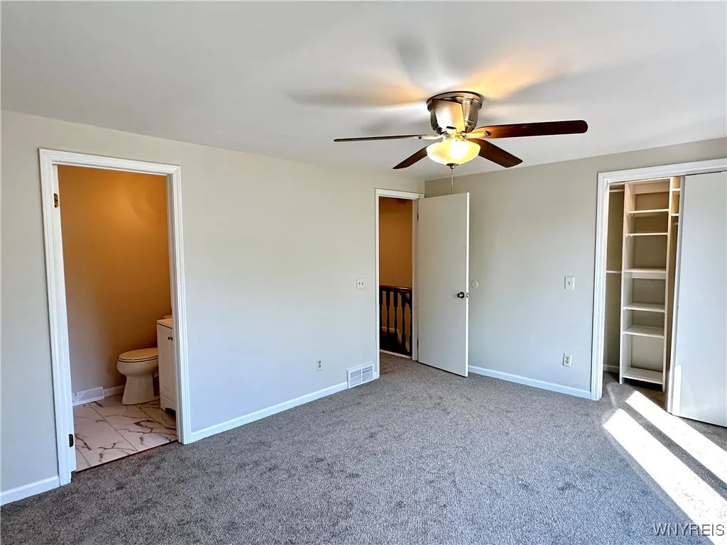 The primary bedroom has an ensuite full bath & walk-in closet w/ organizers.