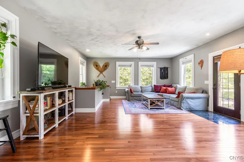 Step into the first-floor family room and notice the tile entrance. The stunning black walnut floors catch your eye, complemented by the striking 9-foot ceilings with detailed designs. Beautiful wide wood trim adds a high level of finish—this home is truly crafted with care.