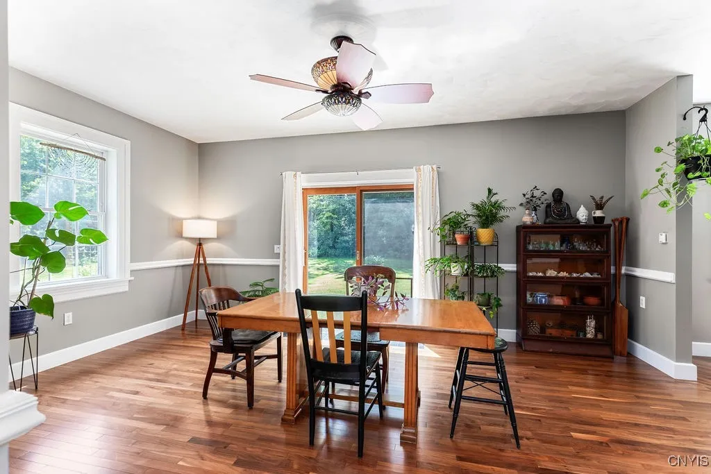 This well-insulated home stays comfortable year-round, with ceiling fans perfectly suited for circulating air in both summer and winter. A sliding door opens to a solid cement patio that spans the length of the home—ideal for relaxing or entertaining. And those walnut floors? Absolutely stunning!





