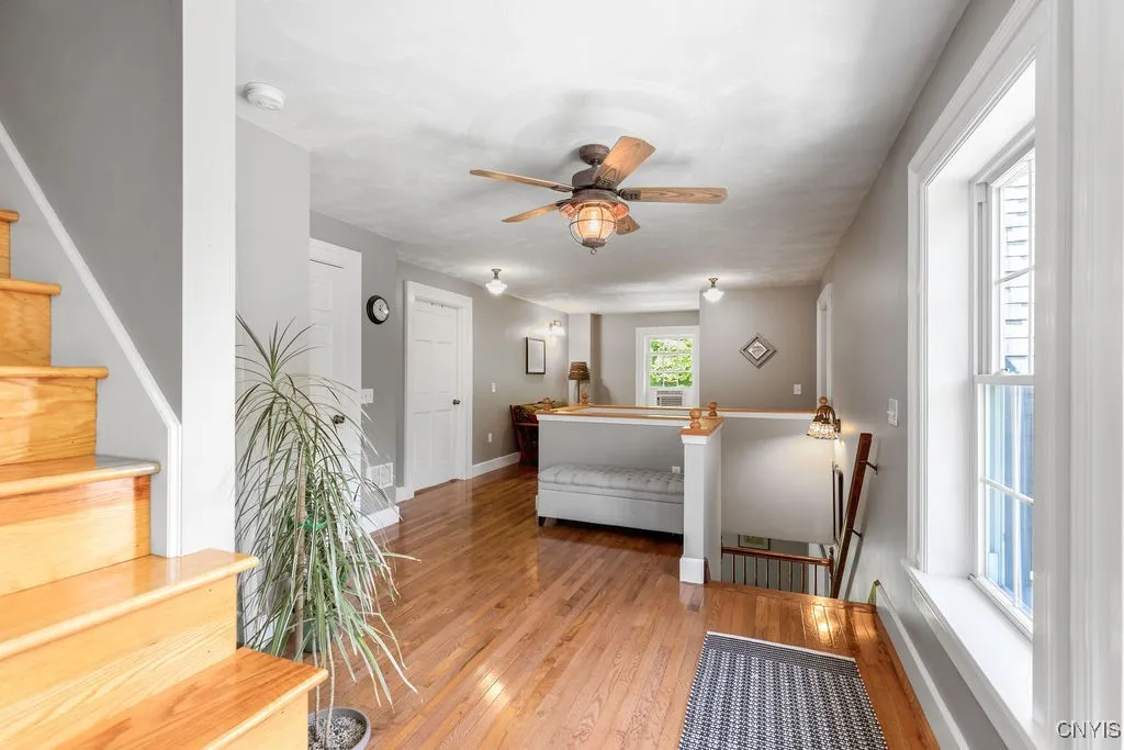 Here’s another view of the second-floor open hallway, which can easily serve as an additional room. Notice the oak staircase that leads up to the third and fourth levels of this special home.