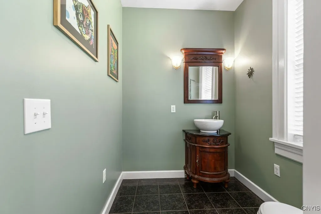 The first-floor half bath is spacious and features a custom vanity—both functional and stylish!





