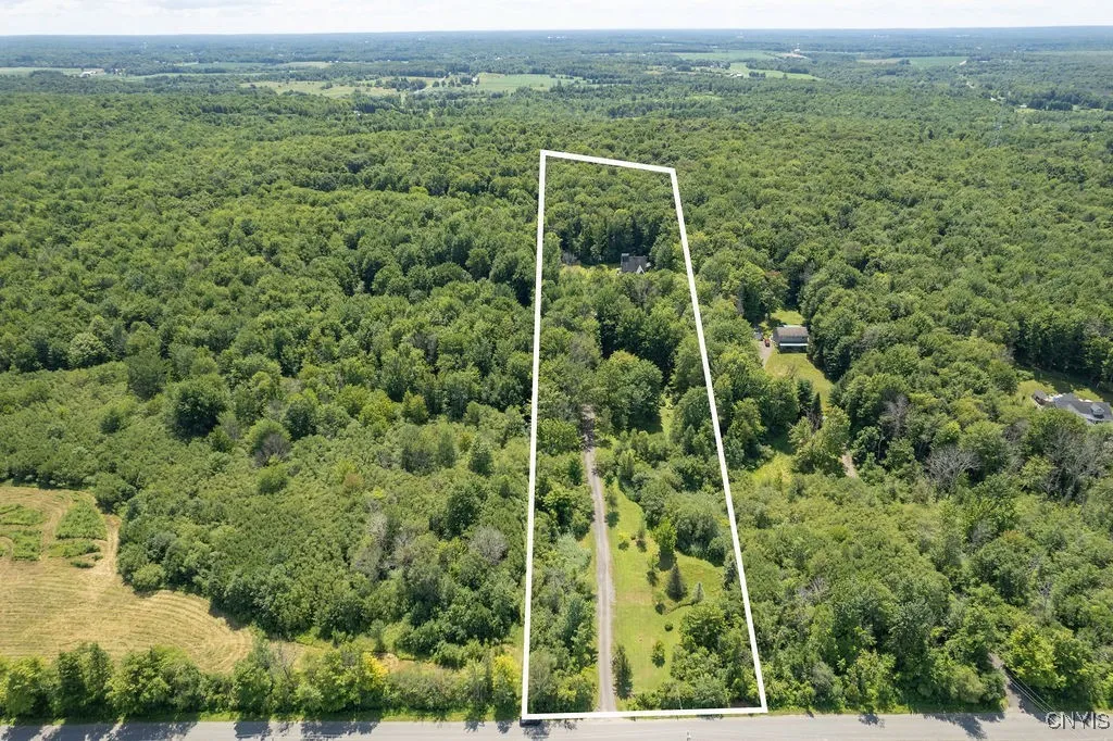 The home sits over 700 feet off Hilton Road, positioned near the center of the lot—extending the backyard even further. The lot feels like a park and includes an added RV spot with water, power, and a 750-gallon septic hookup for family and friends to enjoy.


