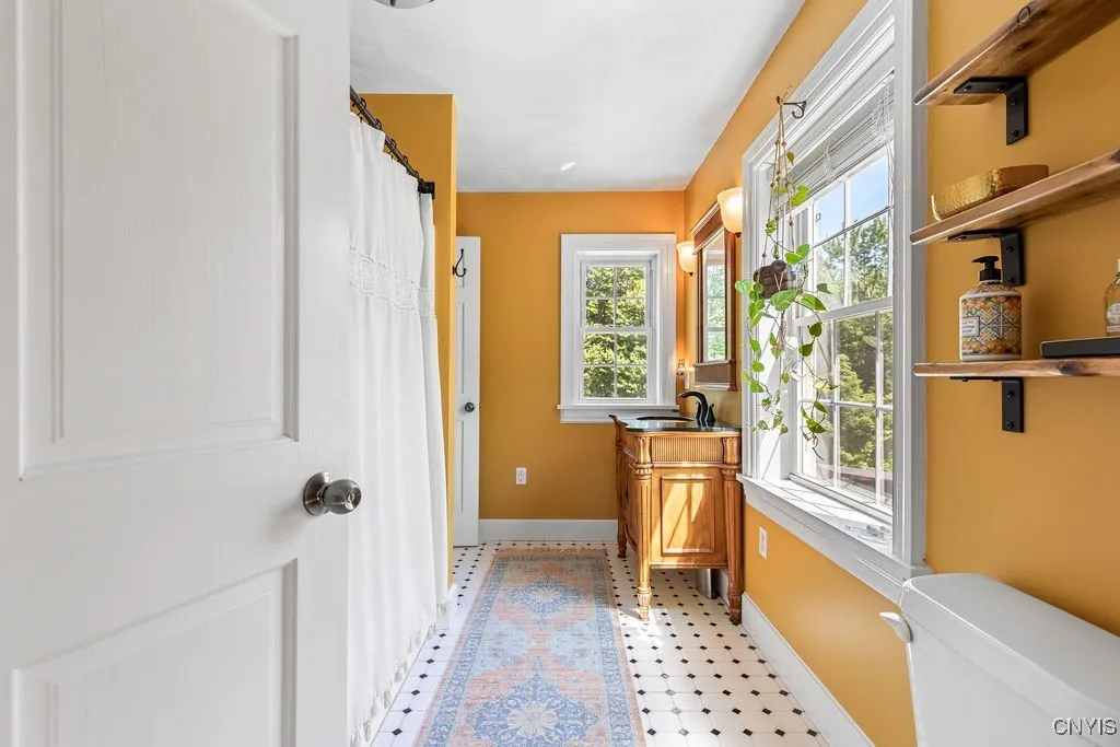 The second-floor full bath features custom tile work and a custom vanity. It’s light, bright, and spacious—truly a beautiful space!





