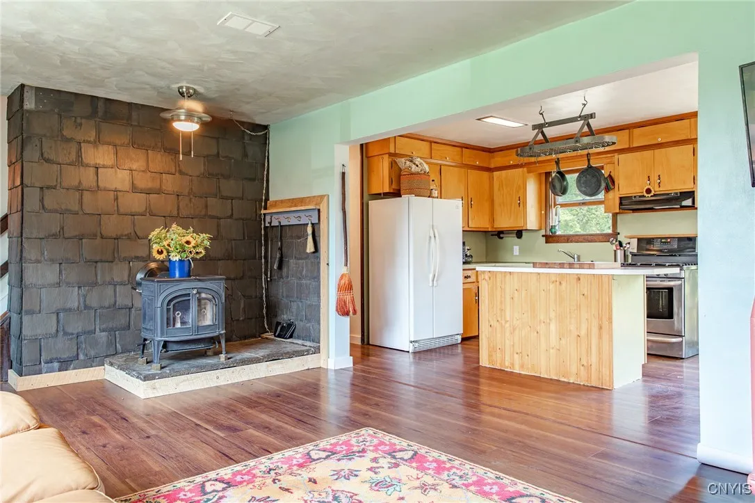 The living room features a wood burning stove