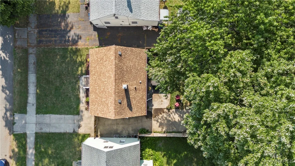 drone footage over the top of the house showing the roof in great condition