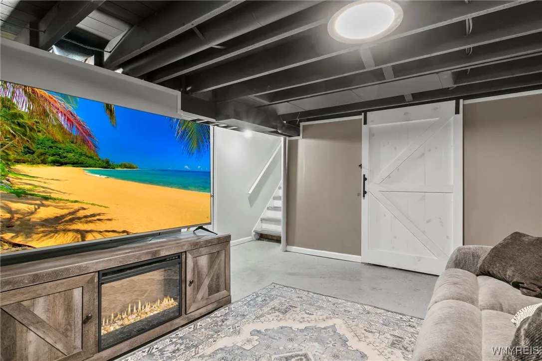all furniture is negotiable including the tv and fireplace entertainment stand - barn door seperates the additional basement bonus room not pictured