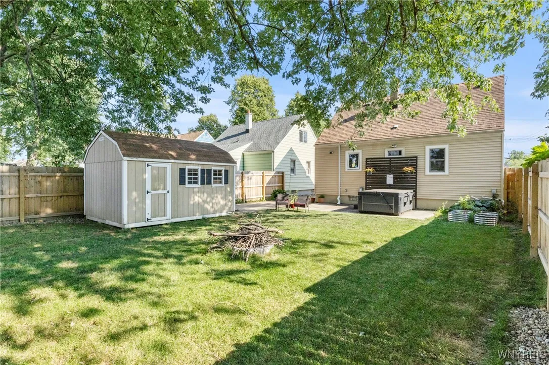 shed with plenty of storage, firepit, and garden beds