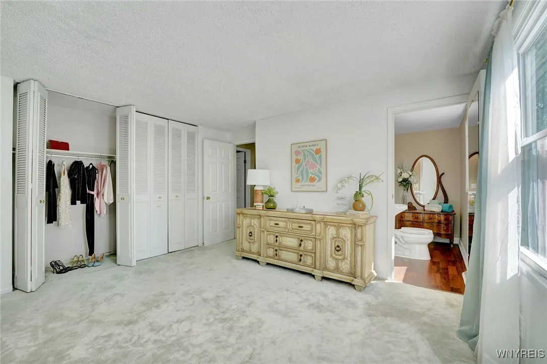 PRIMARY BEDROOM HAS WALL OF DOUBLE CLOSETS (2) AND ITS OWN HALF BATH