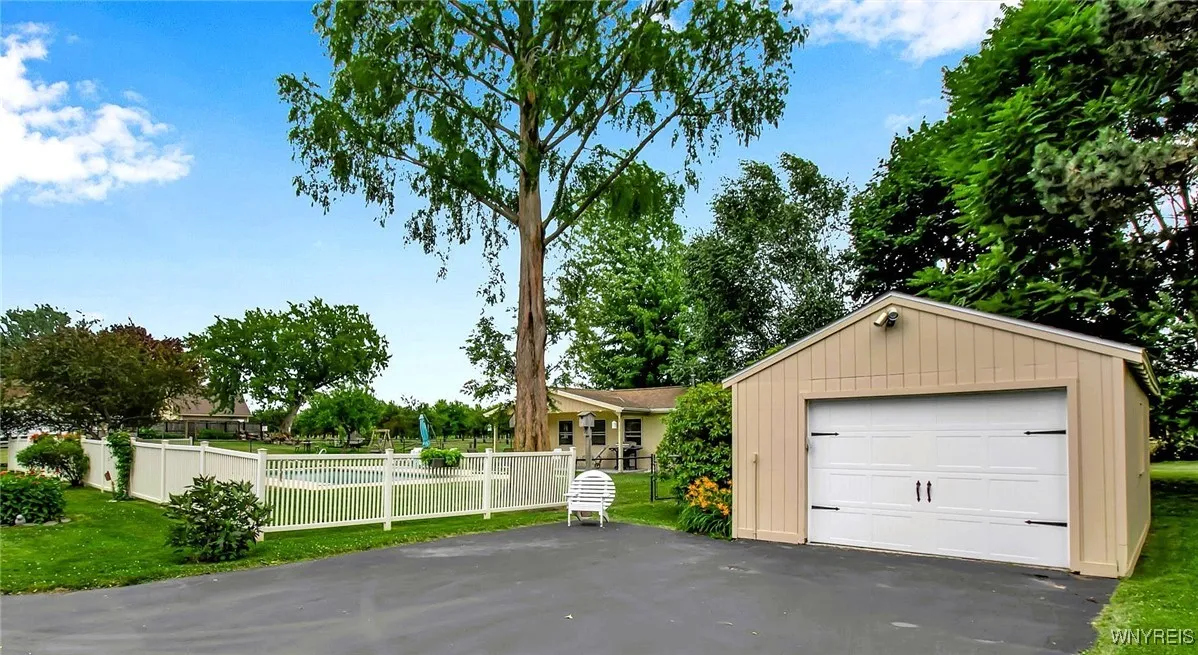 Fenced in pool area and detached garage with additional parking.