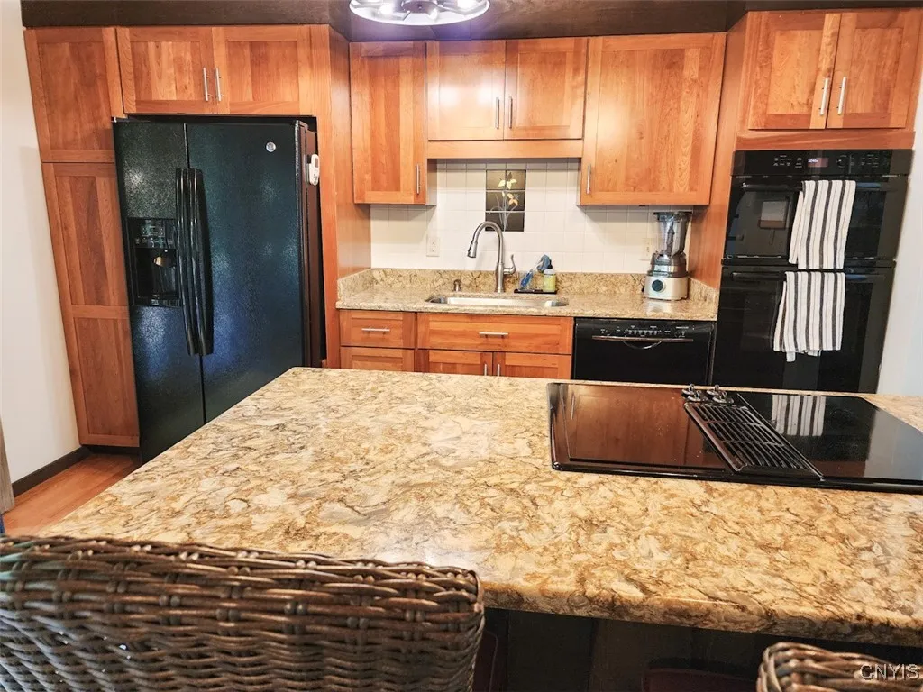 The Cambria Quartz countertop is stunning! This fun kitchen island houses the electric cooktop, and also acts as a convenient breakfast bar.