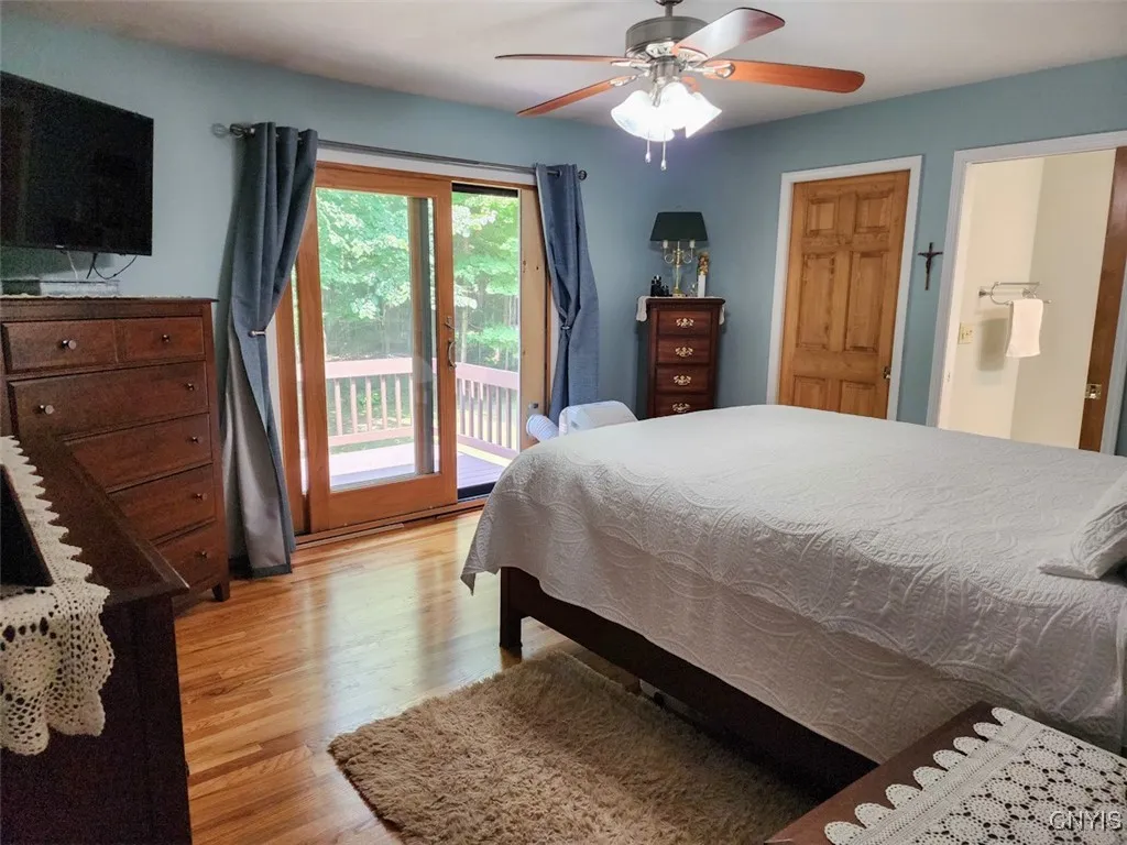 The Primary Suite features gorgeous hardwood floors, a lovely private balcony, and a stunning newly renovated full bathroom.